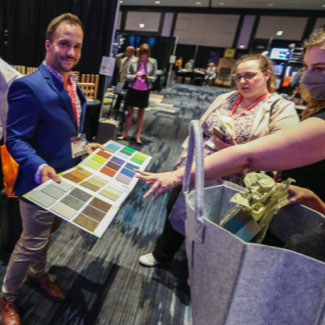 Man presenting color swatches at an event.